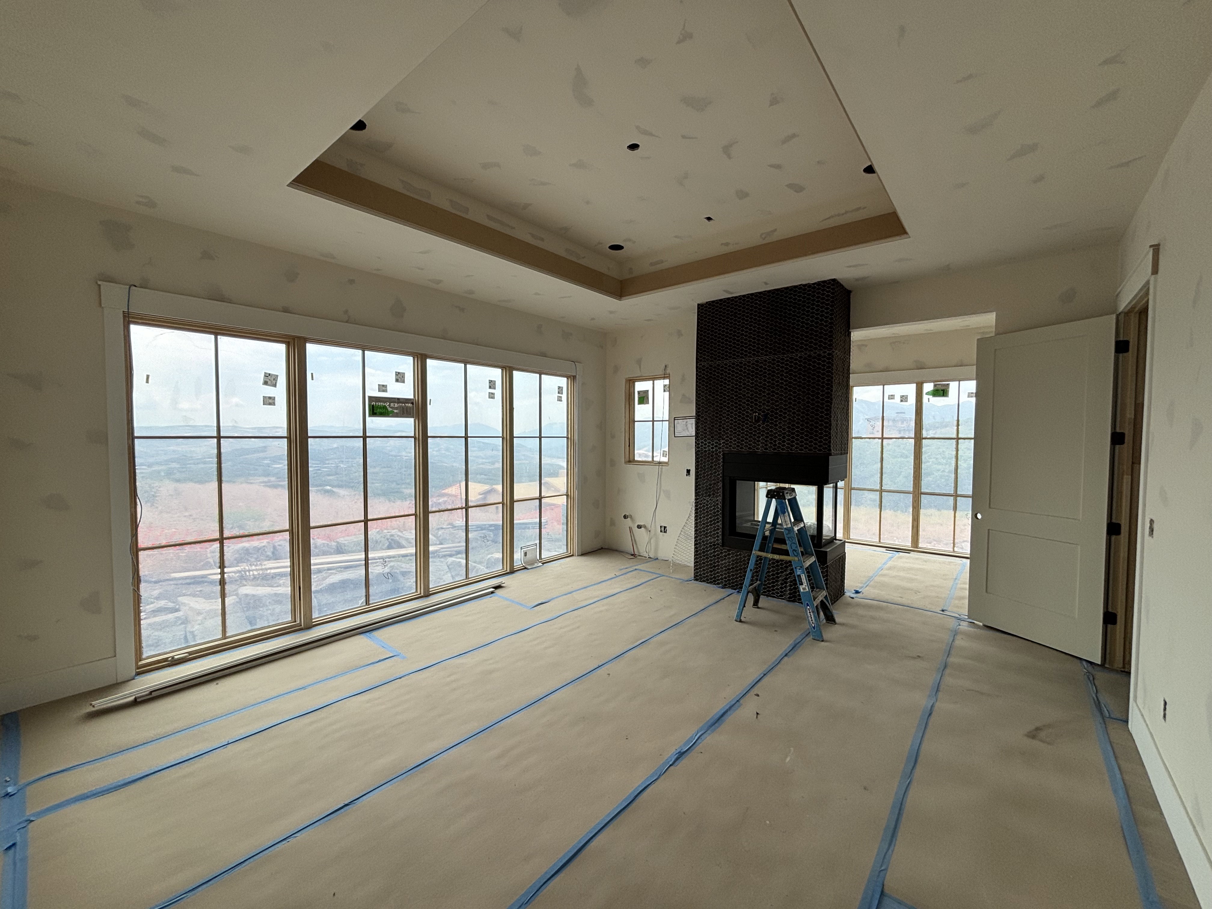 Owner's suite featuring a peninsula fireplace