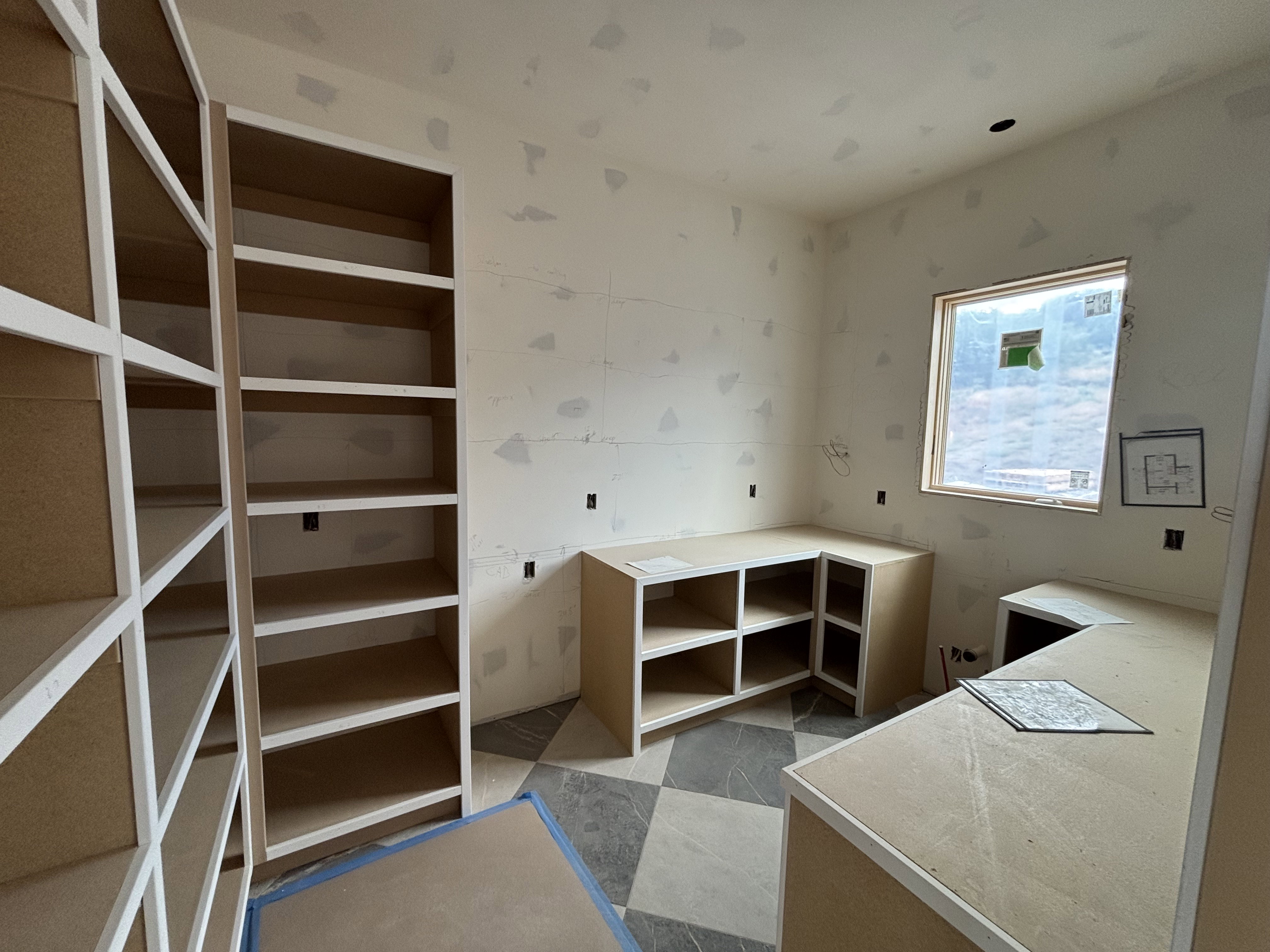 Pantry featuring checkered floor tiling, and a window providing natural light