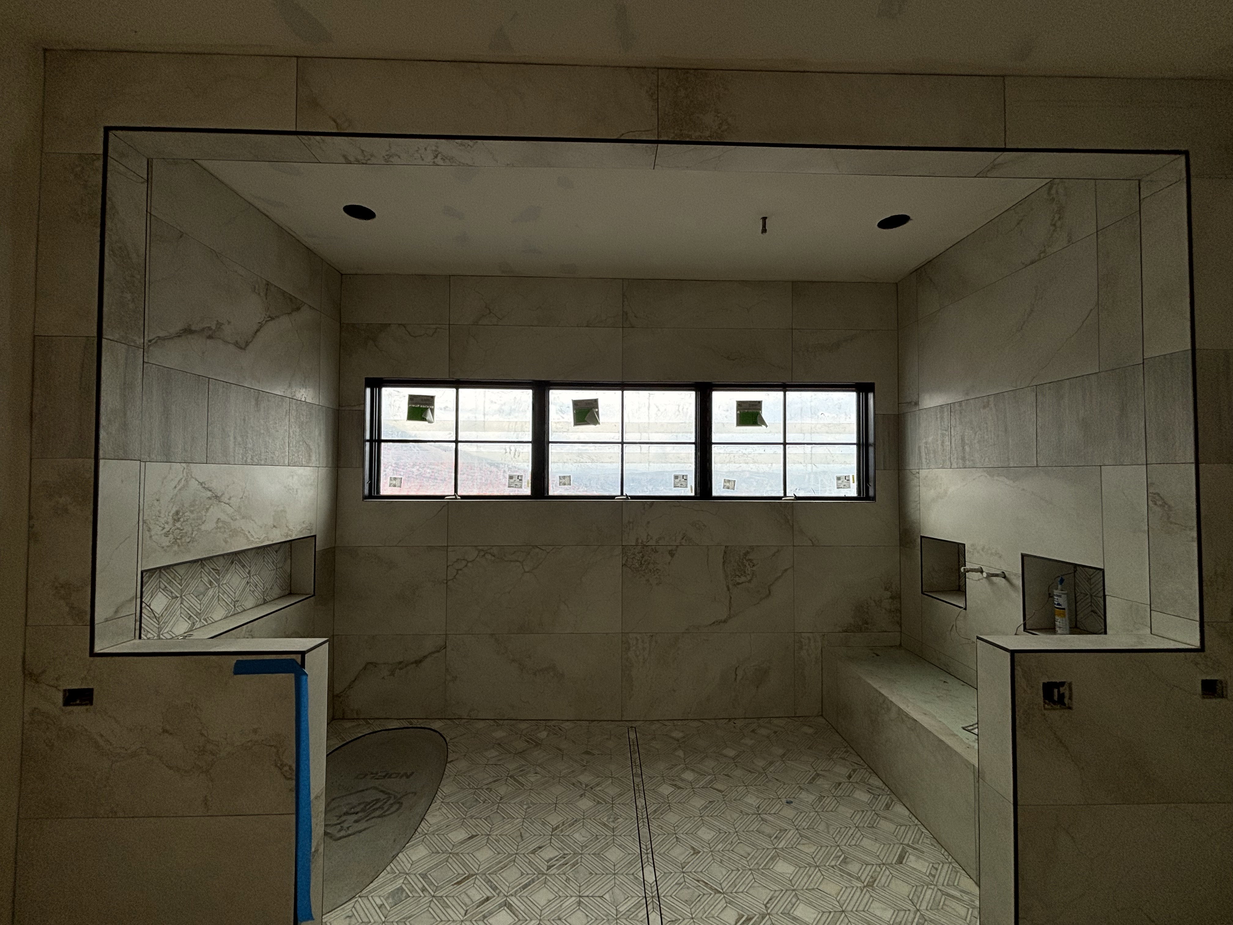 Master bathroom shower featuring multiple built-in niches, and a functional integrated bench, and views of Mount Timpanogos and Jordanelle Reservoir