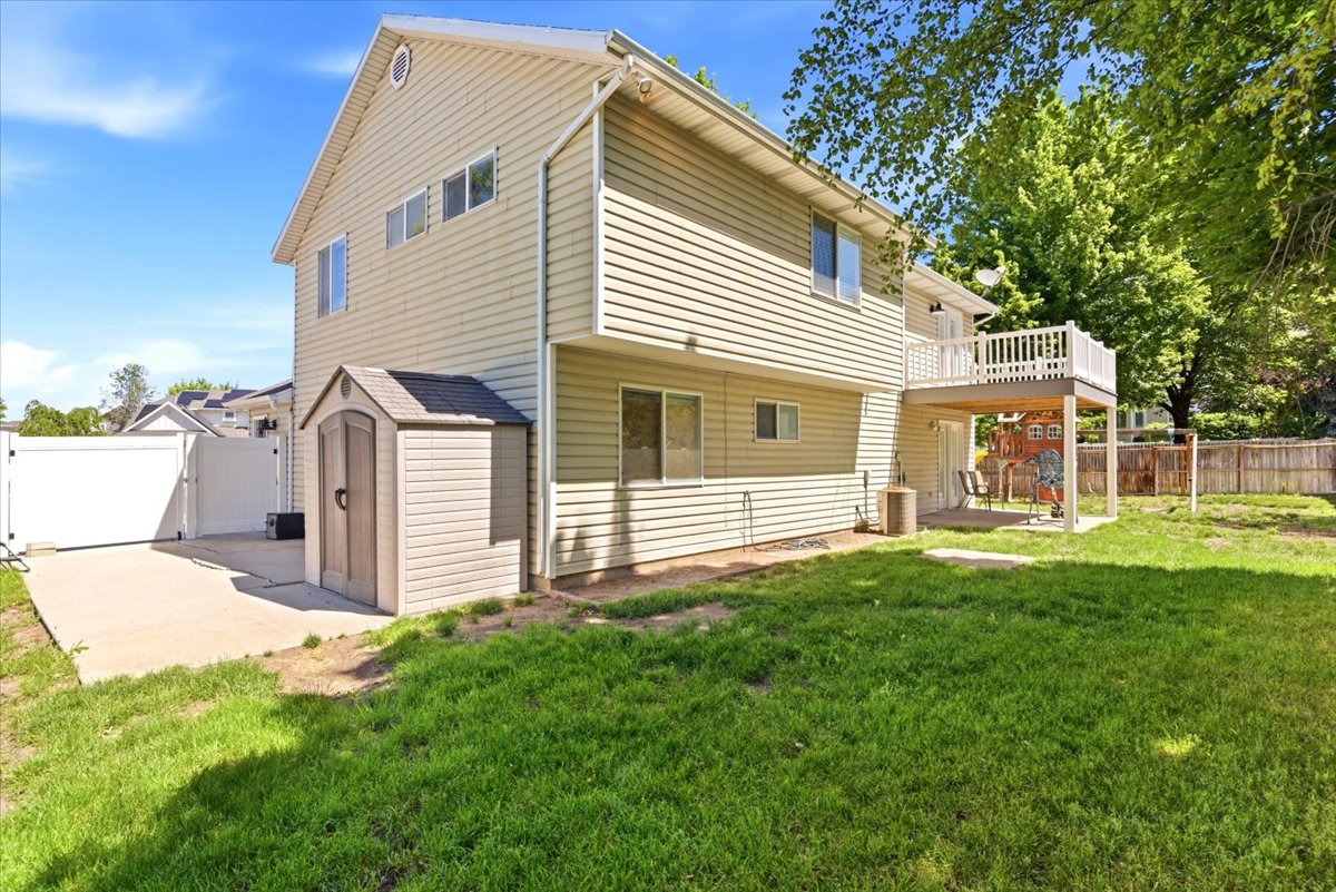 Rear exterior of the property featuring a two-story structure with horizontal siding and multiple windows