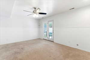 Neutral wall finishes with wainscoting and a ceiling fan with integrated lighting