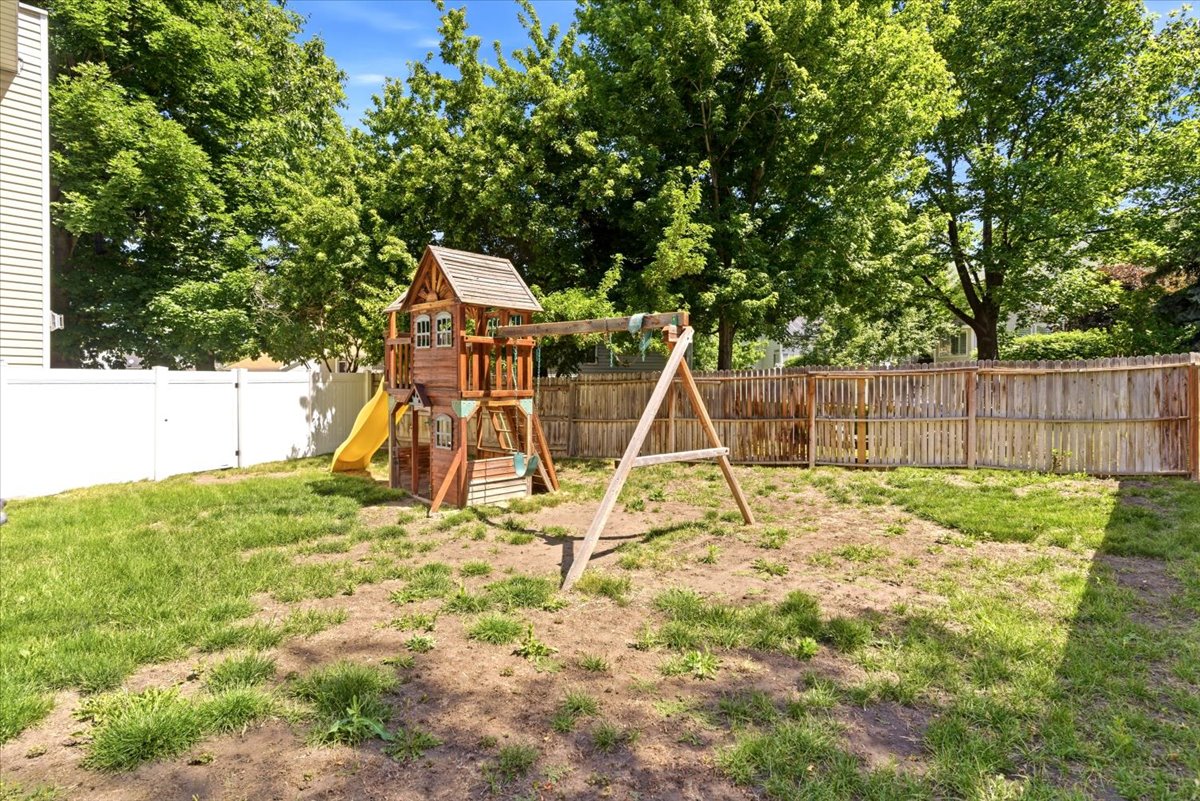 Expansive backyard featuring a combination of wood and vinyl fencing