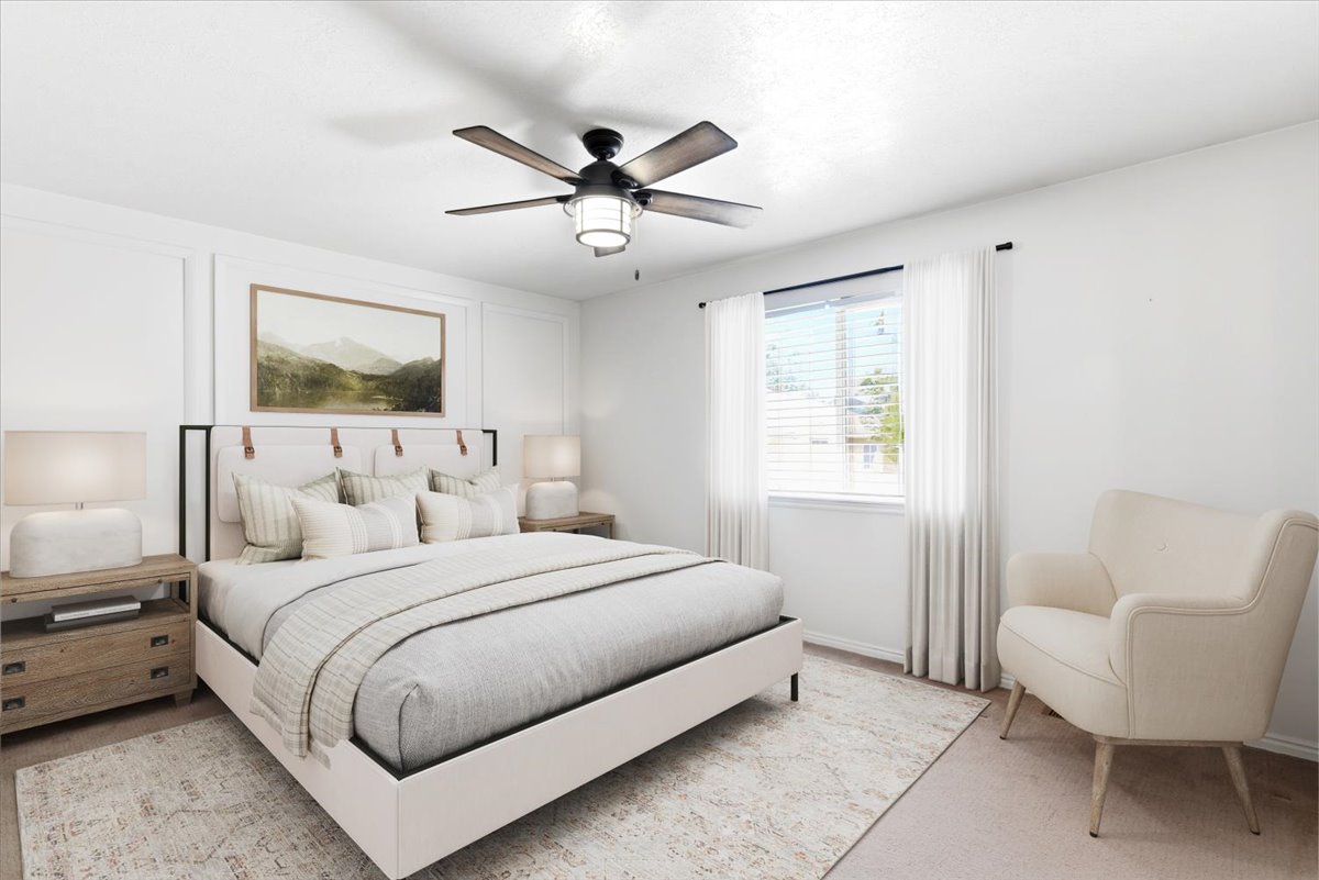 Bedroom featuring a ceiling fan with integrated lighting, a window with blinds and sheer curtains, and wainscoting detailing on the wall