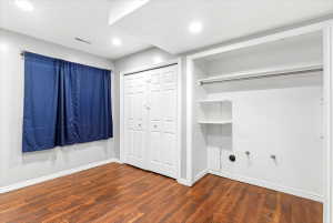 Room featuring wood-finish flooring, recessed lighting, and a window with a curtain rod