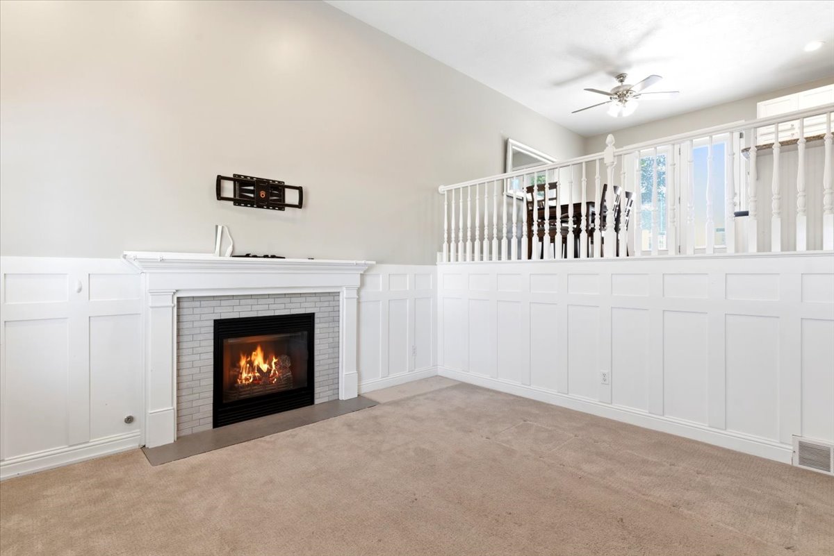 Fireplace with a white mantel and light gray subway tile surround