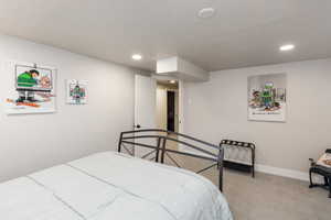 Bedroom featuring neutral wall paint, recessed lighting, and light-toned carpet flooring
