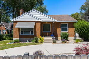 Brick exterior with white siding accents and a pitched roof