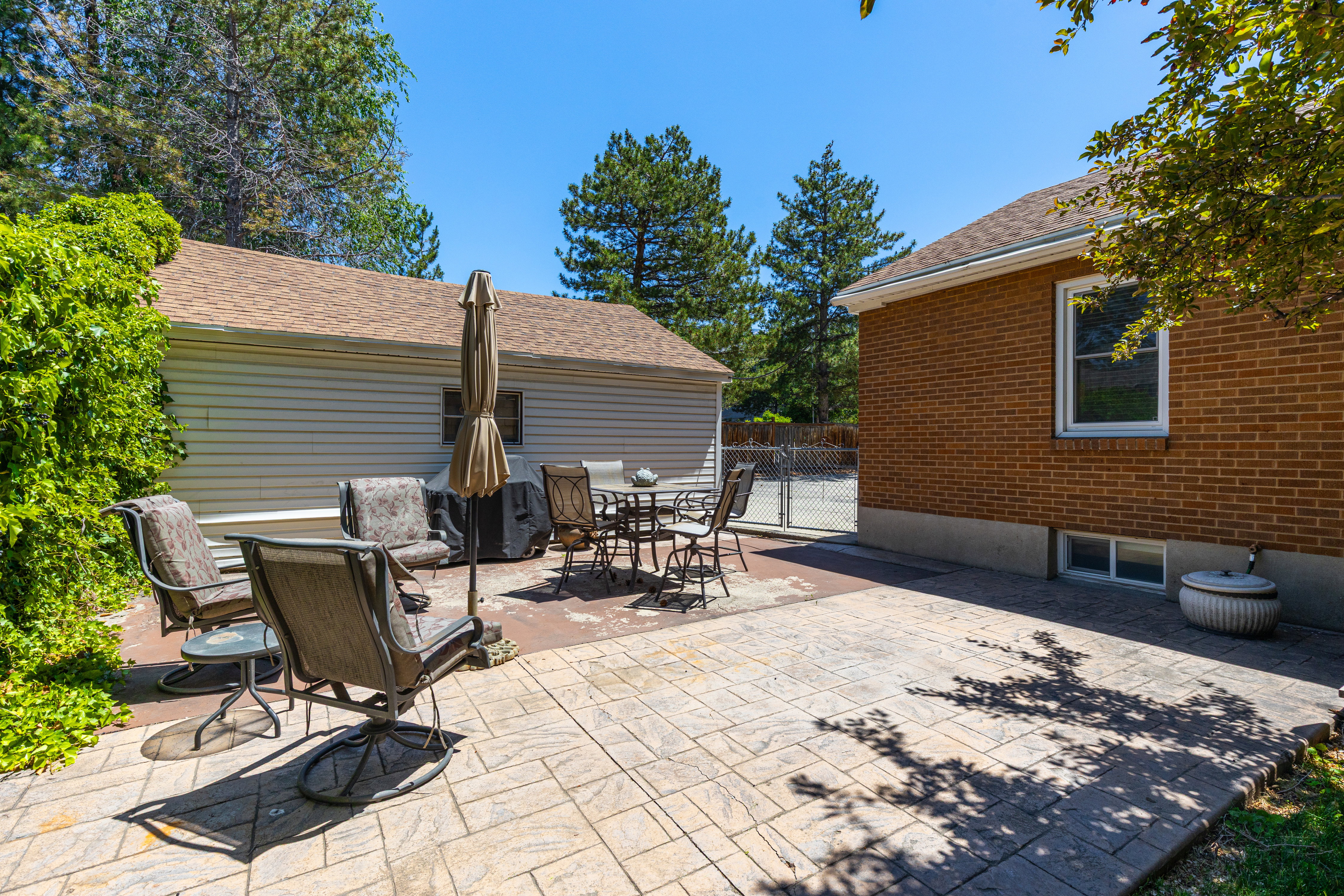 Expansive outdoor patio area featuring stamped concrete and brick paver sections