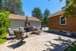 Expansive outdoor patio area featuring stamped concrete and brick paver sections