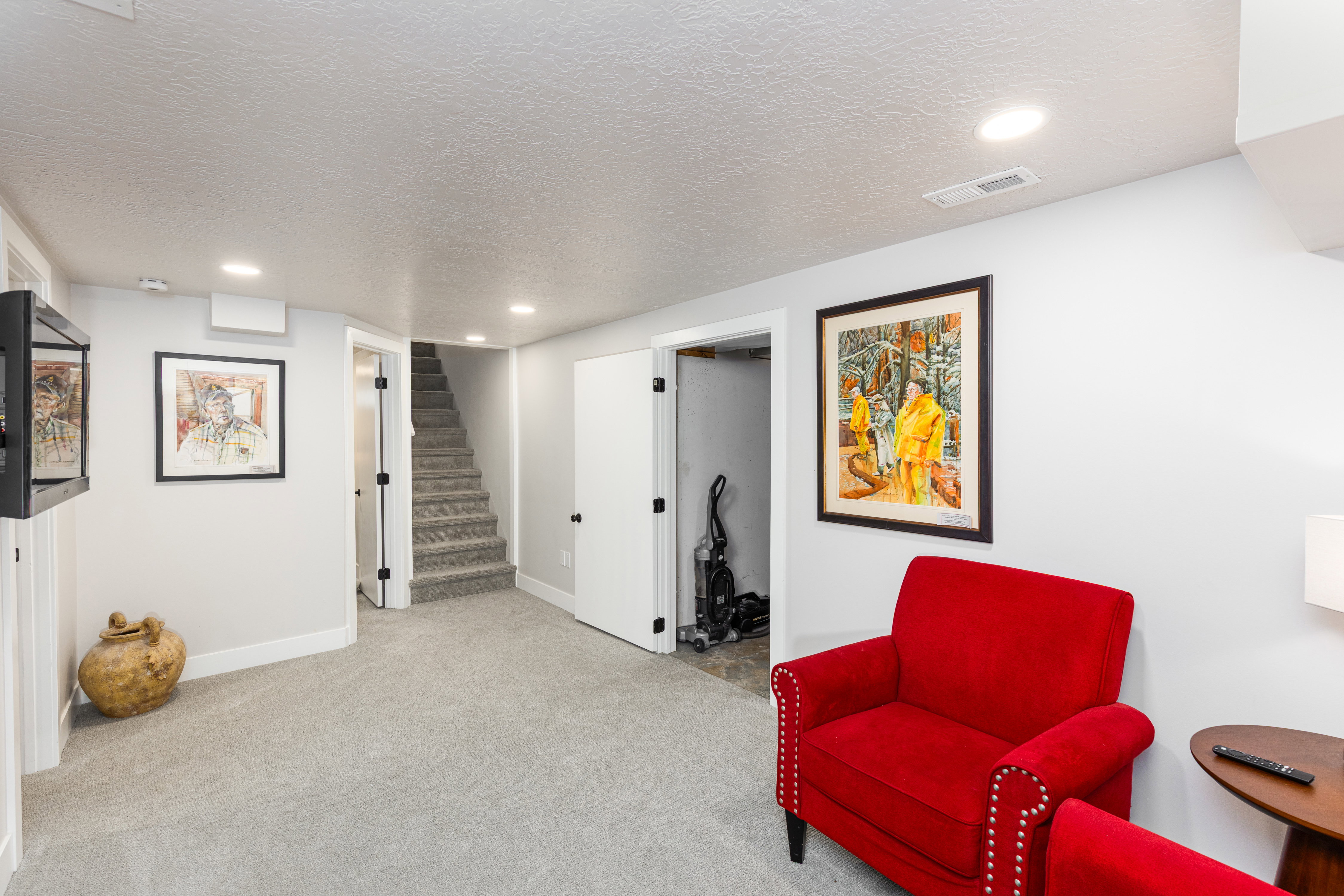 Carpeted lower-level room featuring recessed lighting, light gray walls, and white trim