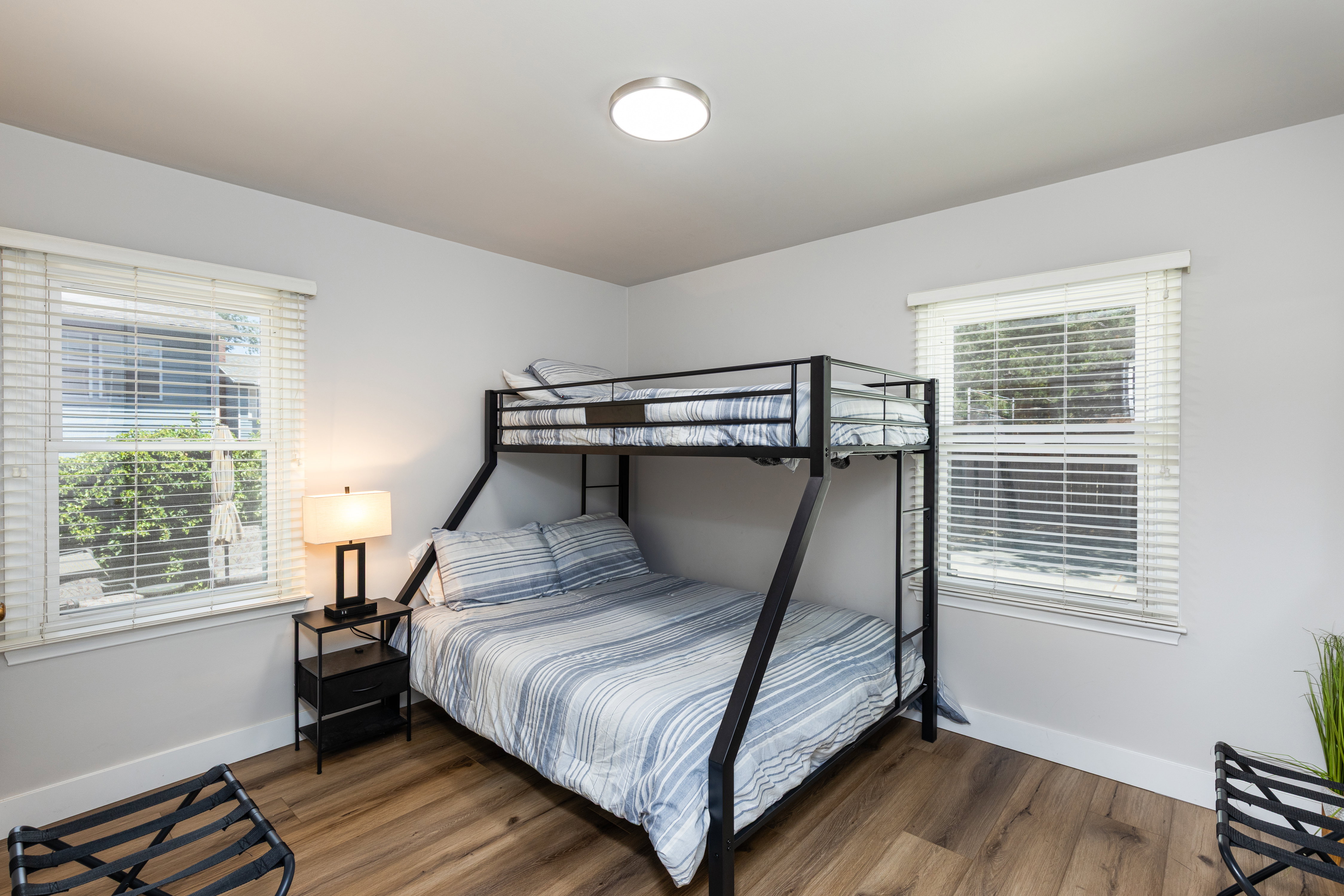 Room featuring wood-finish flooring, light grey painted walls, and white baseboards