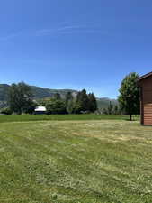 Expansive green lawn with mountain backdrop