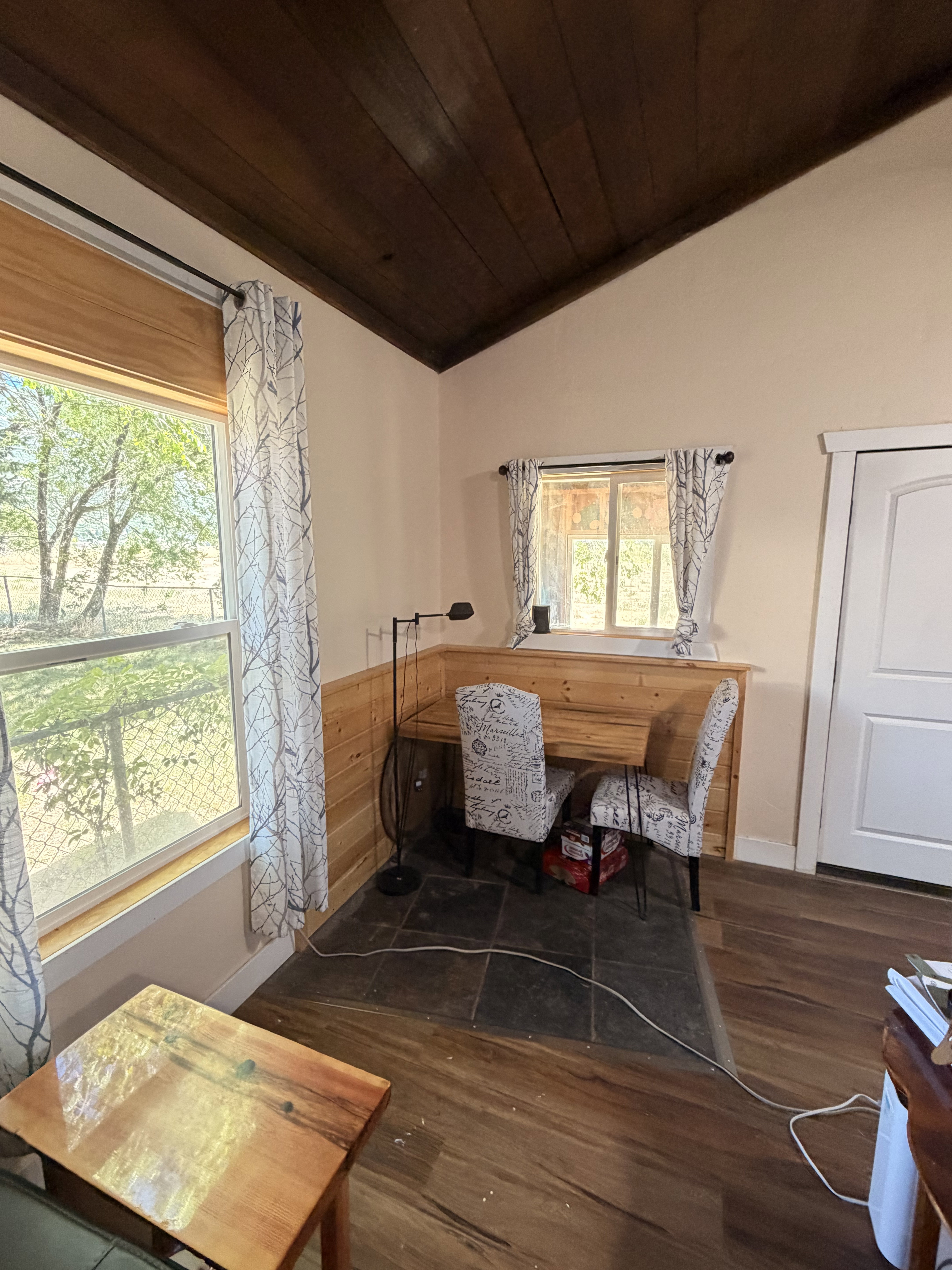 Vaulted wood-paneled ceiling with natural light from multiple windows