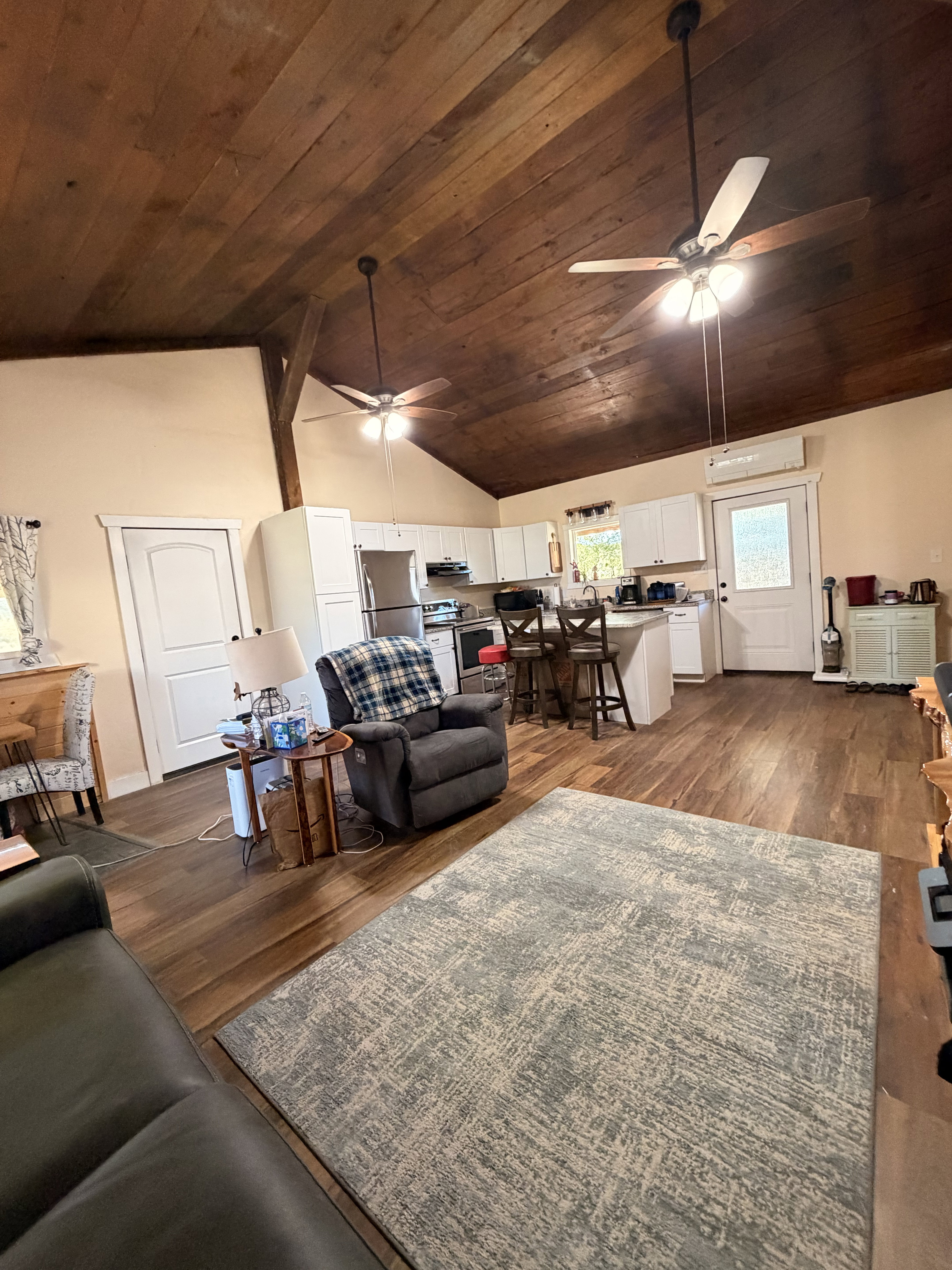 Vaulted wood-plank ceiling with dual ceiling fans