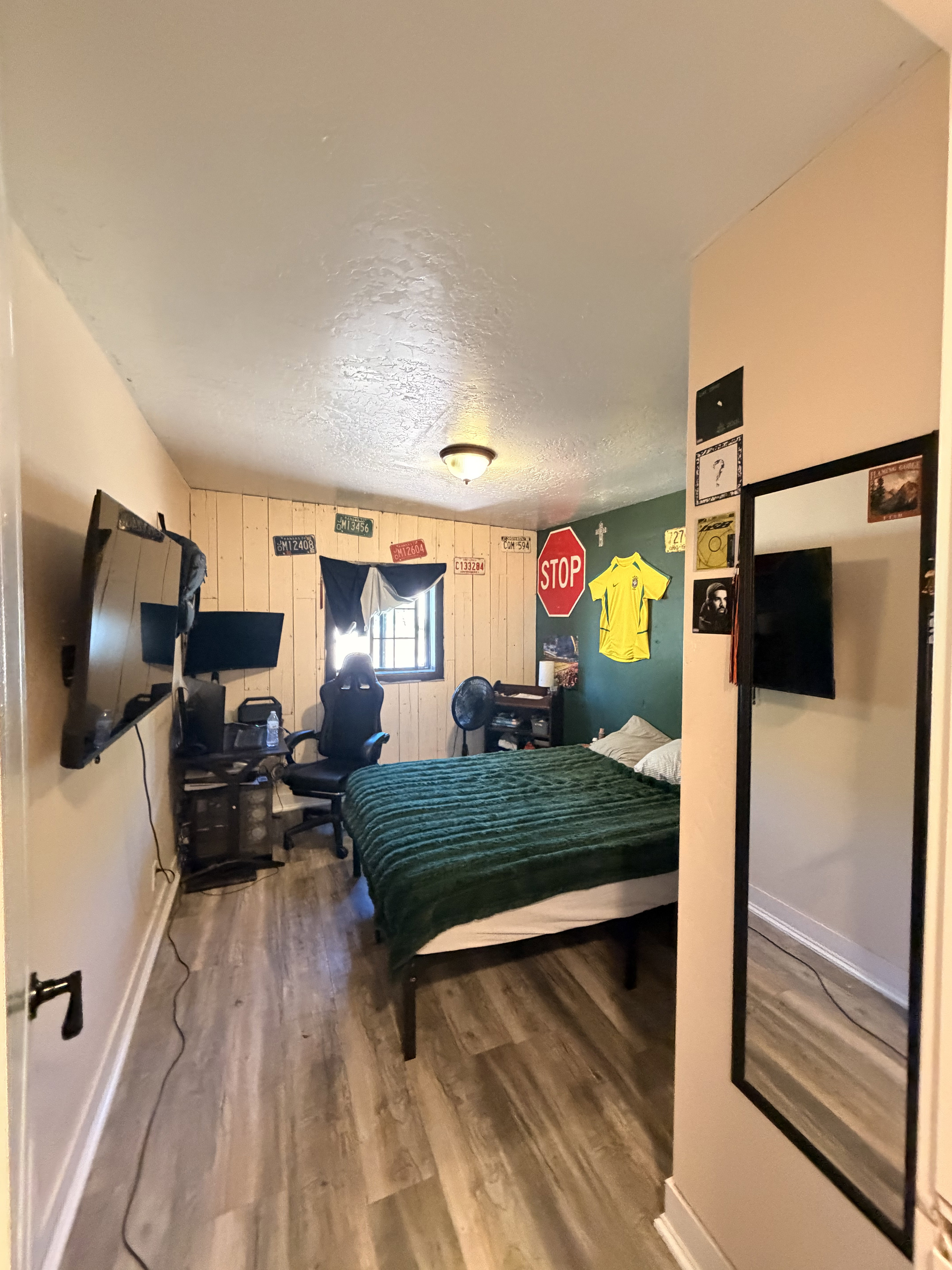 Room featuring wood-finish flooring, a neutral wall color, and a window with natural light