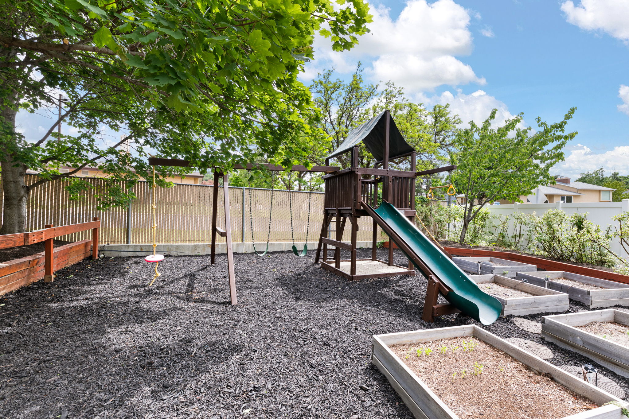 Outdoor play structure featuring a slide and swing set