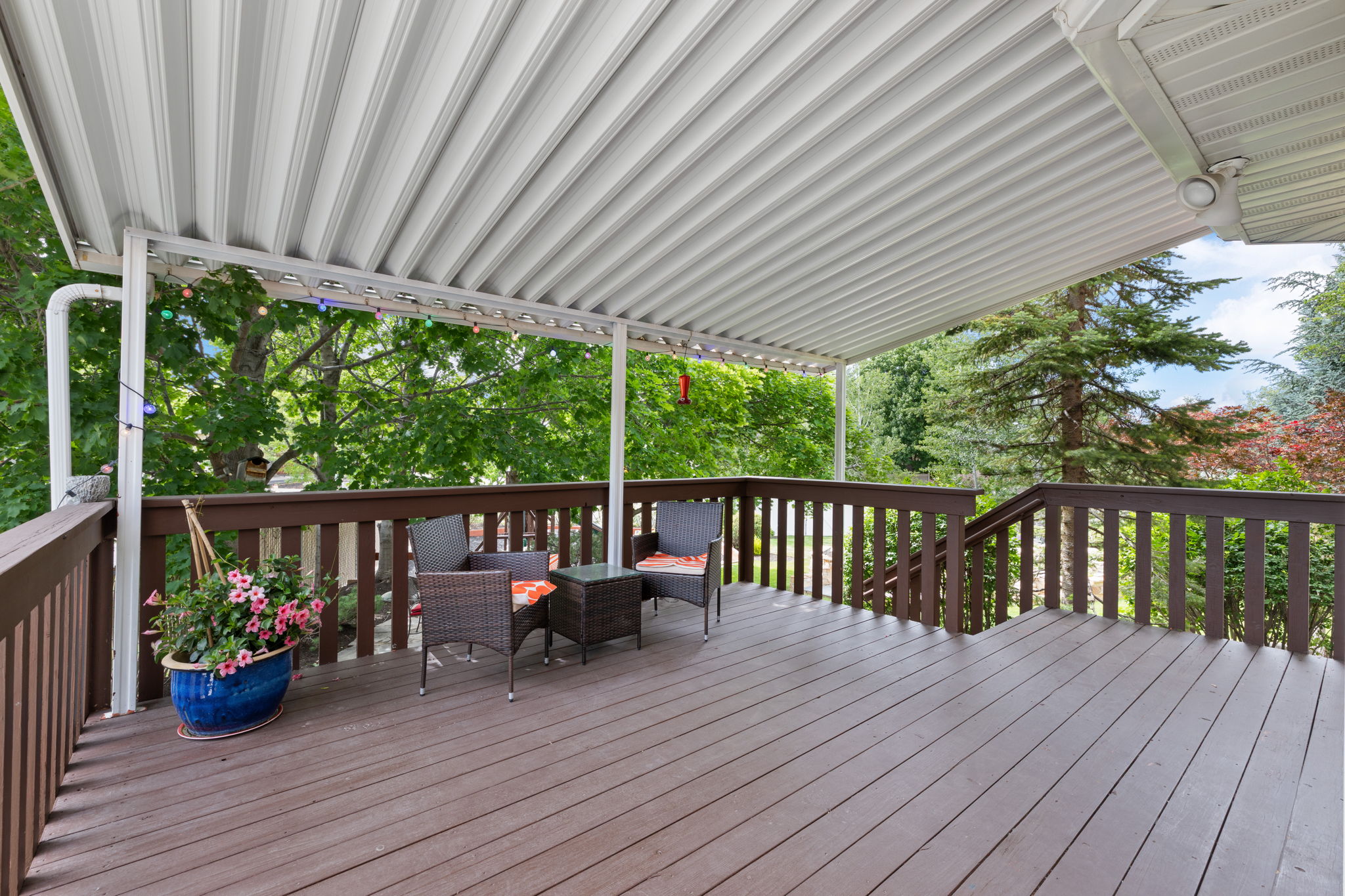 Expansive outdoor deck just off the kitchen featuring a full overhead covering