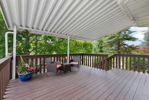 Expansive outdoor deck just off the kitchen featuring a full overhead covering
