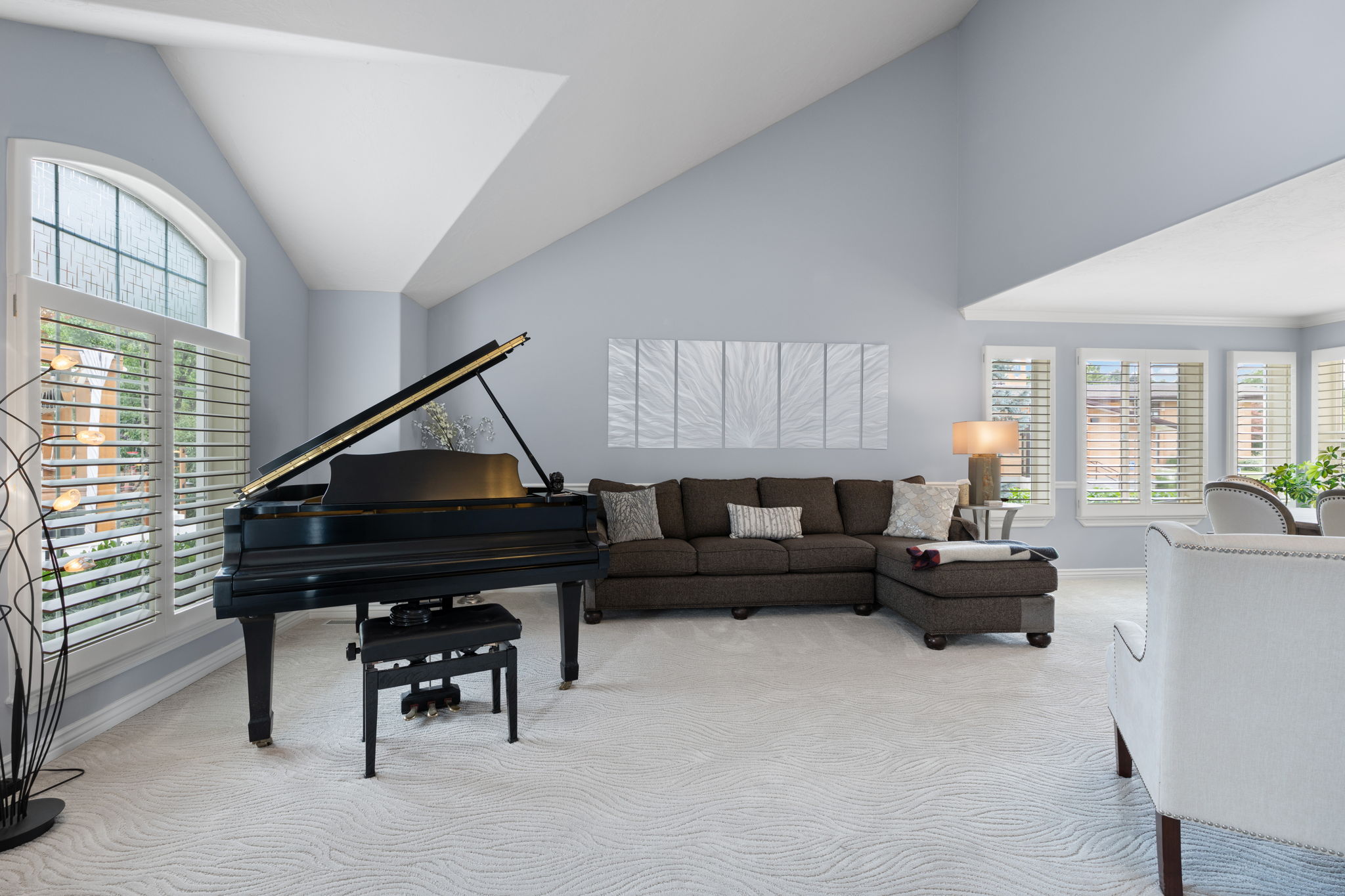 Front living space with vaulted ceilings and natural light