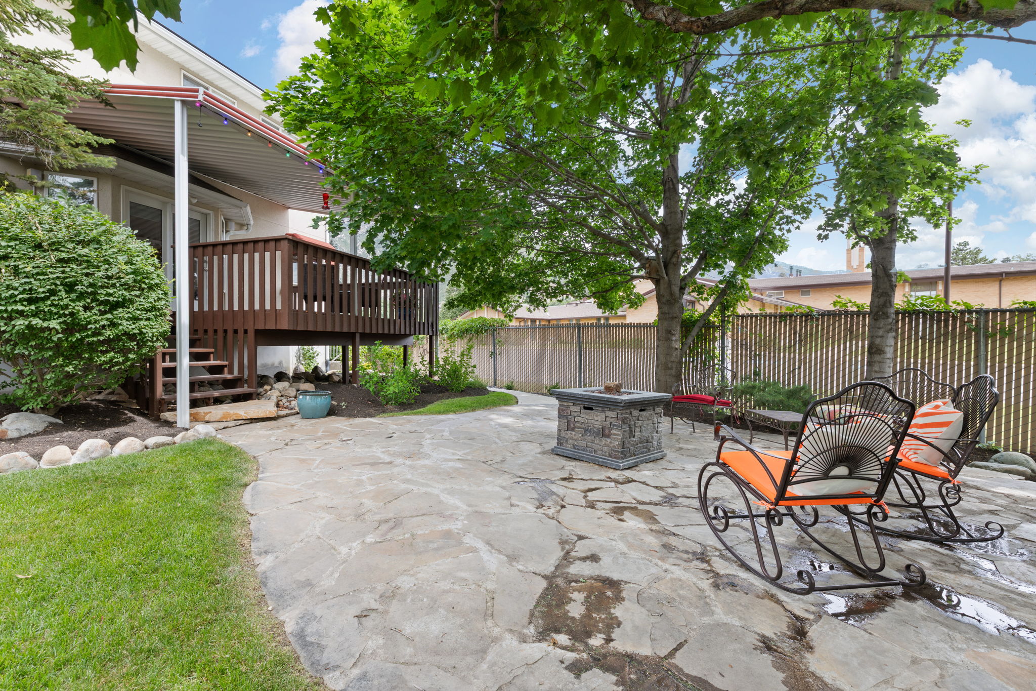 Expansive flagstone patio featuring a built-in fire pit