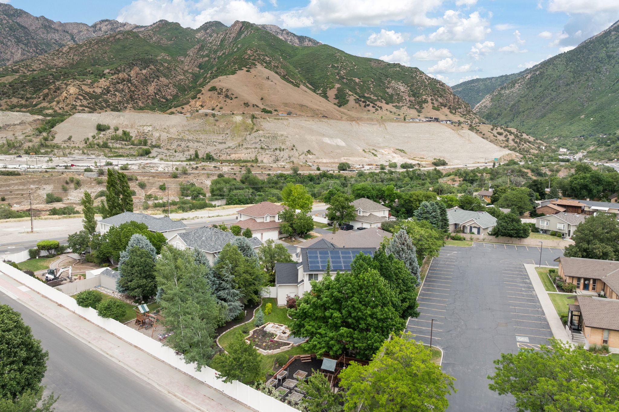 Residential community featuring various architectural styles, established landscaping, and mountain backdrop