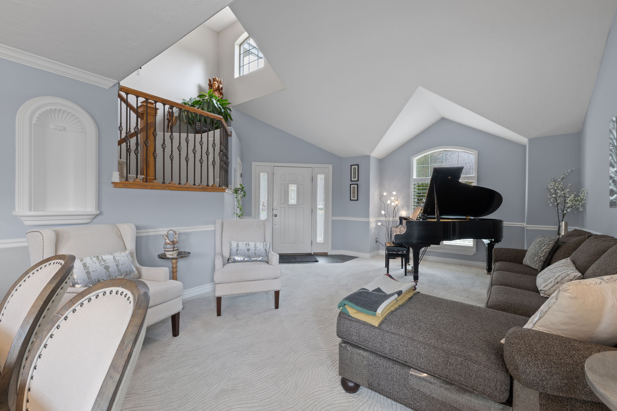 Front living space with vaulted ceilings and natural light