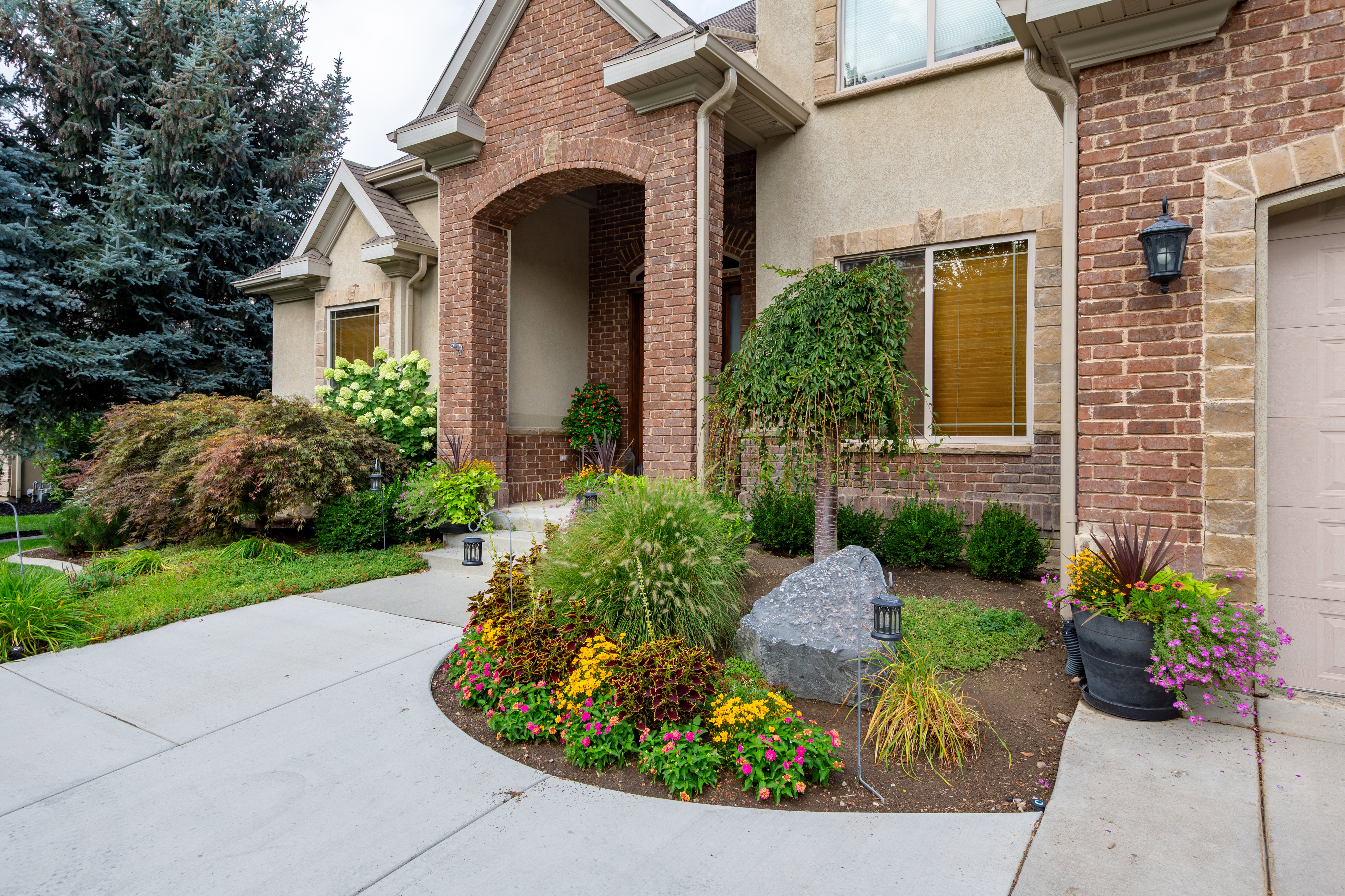 Brick and stucco exterior with an arched entry