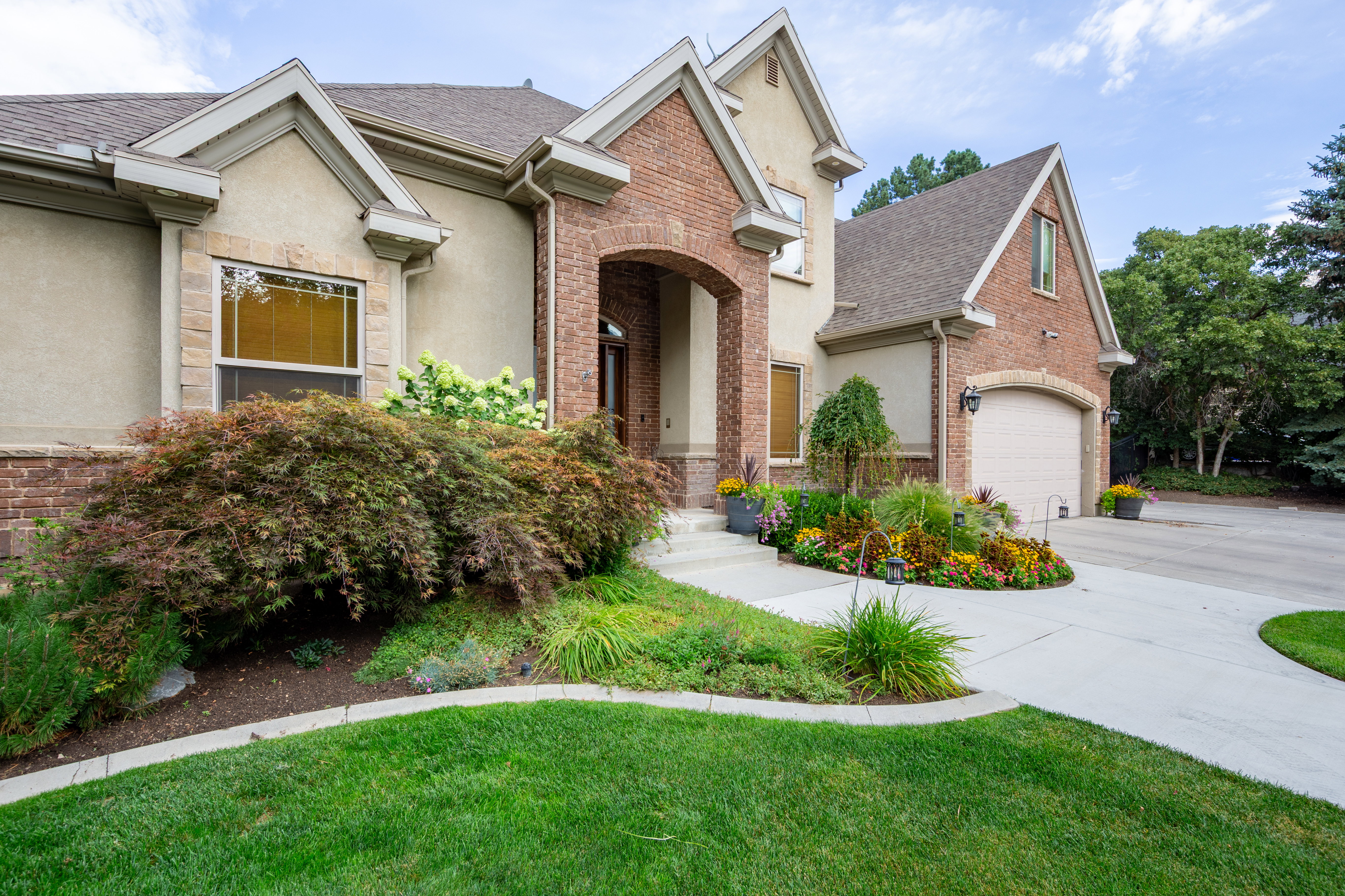 Stucco and brick exterior with arched entry