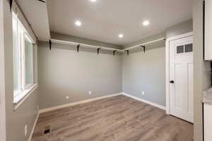 Contemporary interior space featuring wood-finish flooring and recessed lighting
