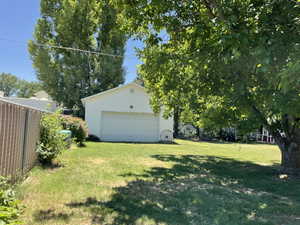 Detached garage with a white overhead door and white siding