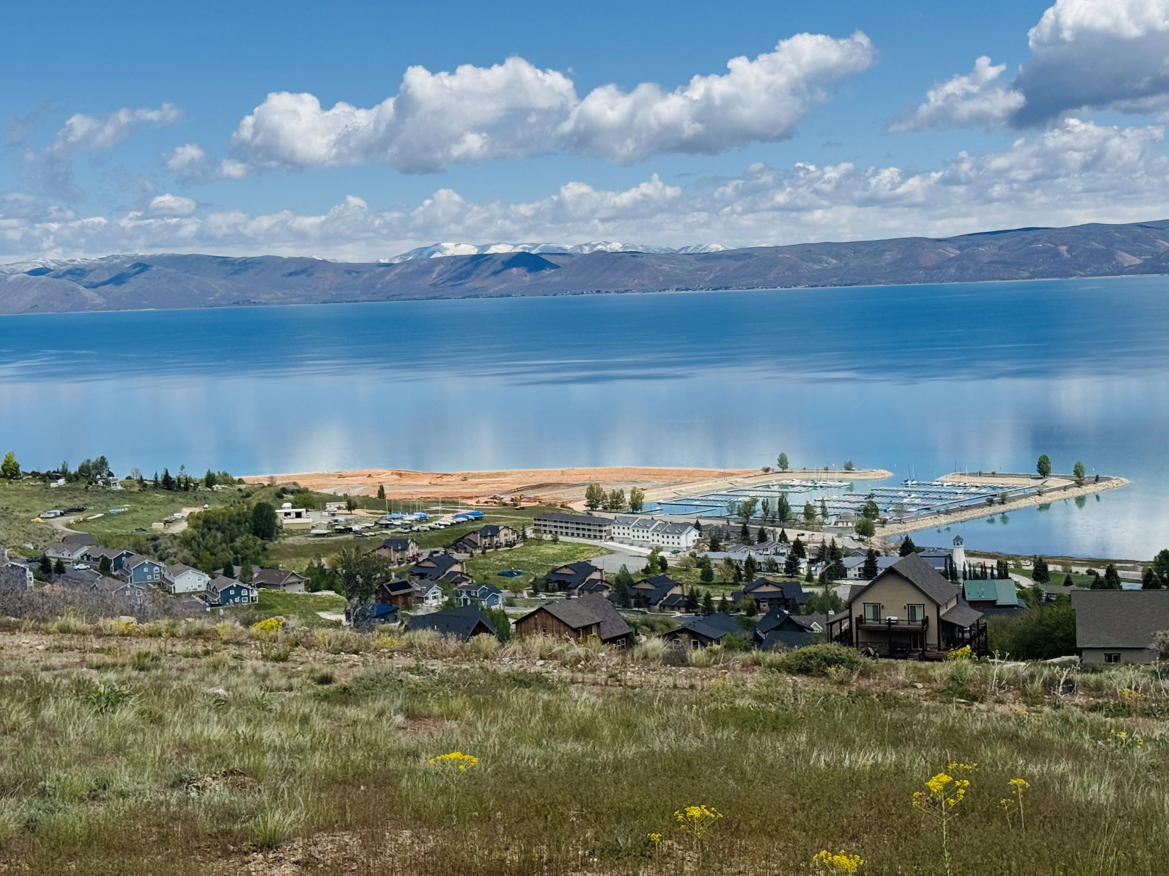 Expansive water body with a marina and adjacent residential structures