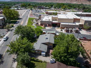 Aerial view of a property featuring a metal roof and a fenced yard