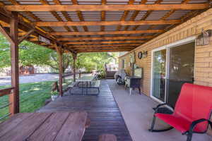 Covered outdoor deck with exposed wood rafters and a corrugated metal roof