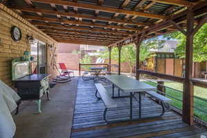 Outdoor living space featuring a covered patio and an elevated wooden deck