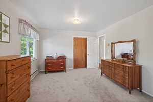 Carpeted room featuring a double-paned window, neutral wall paint, and a white interior door