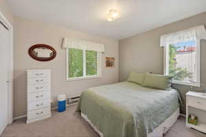 Carpeted room with neutral wall tones and a ceiling-mounted light fixture