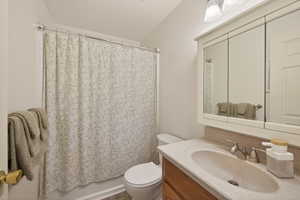 Bathroom featuring a shower-tub combination, single vanity with integrated sink, and triple mirrored medicine cabinet