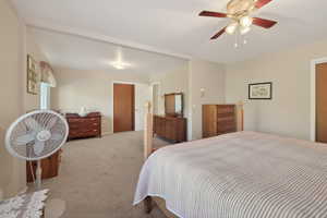 Carpeted interior space featuring a ceiling fan with integrated lighting