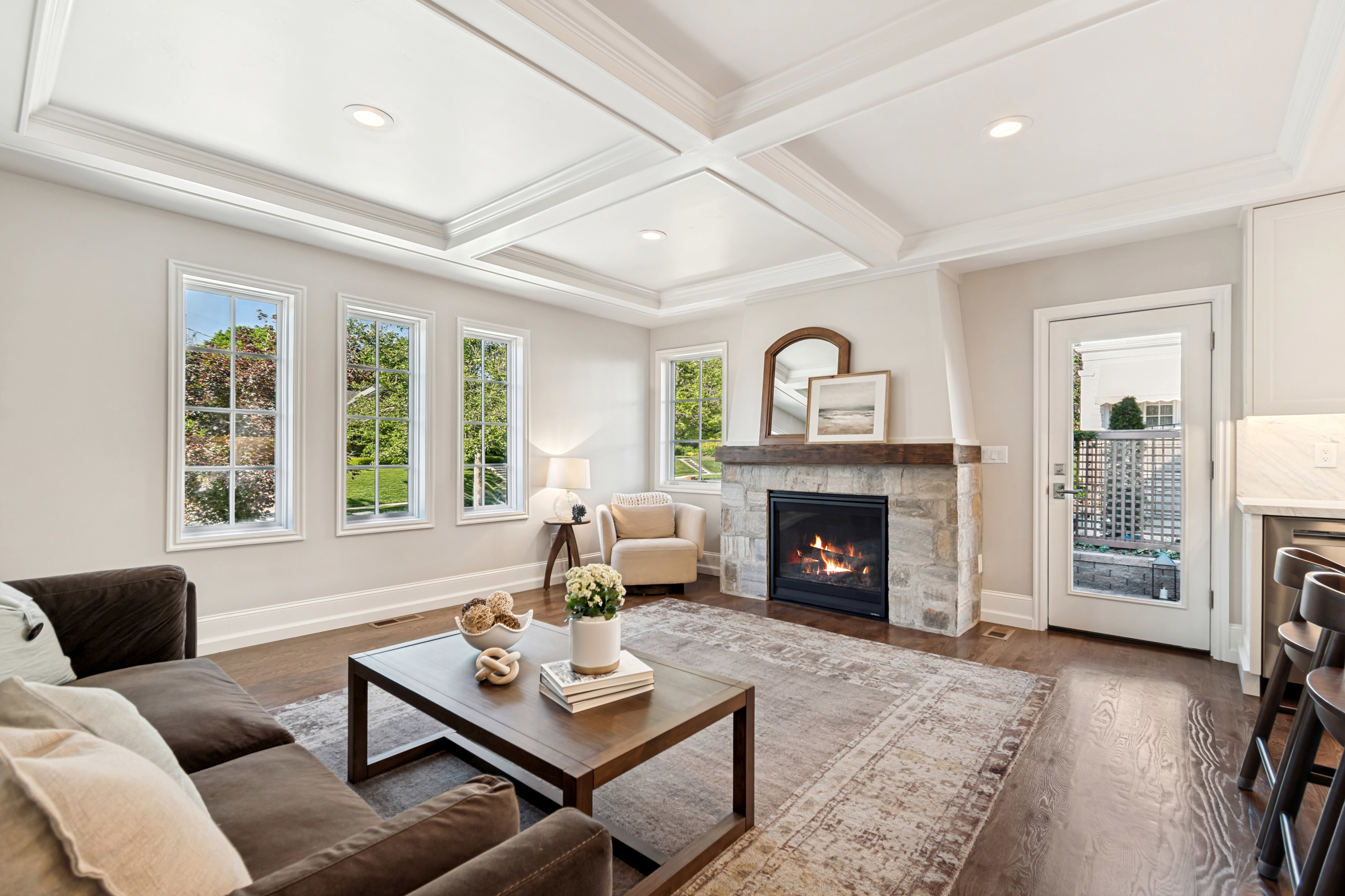Living area featuring wood-finish flooring, a coffered ceiling, and recessed lighting