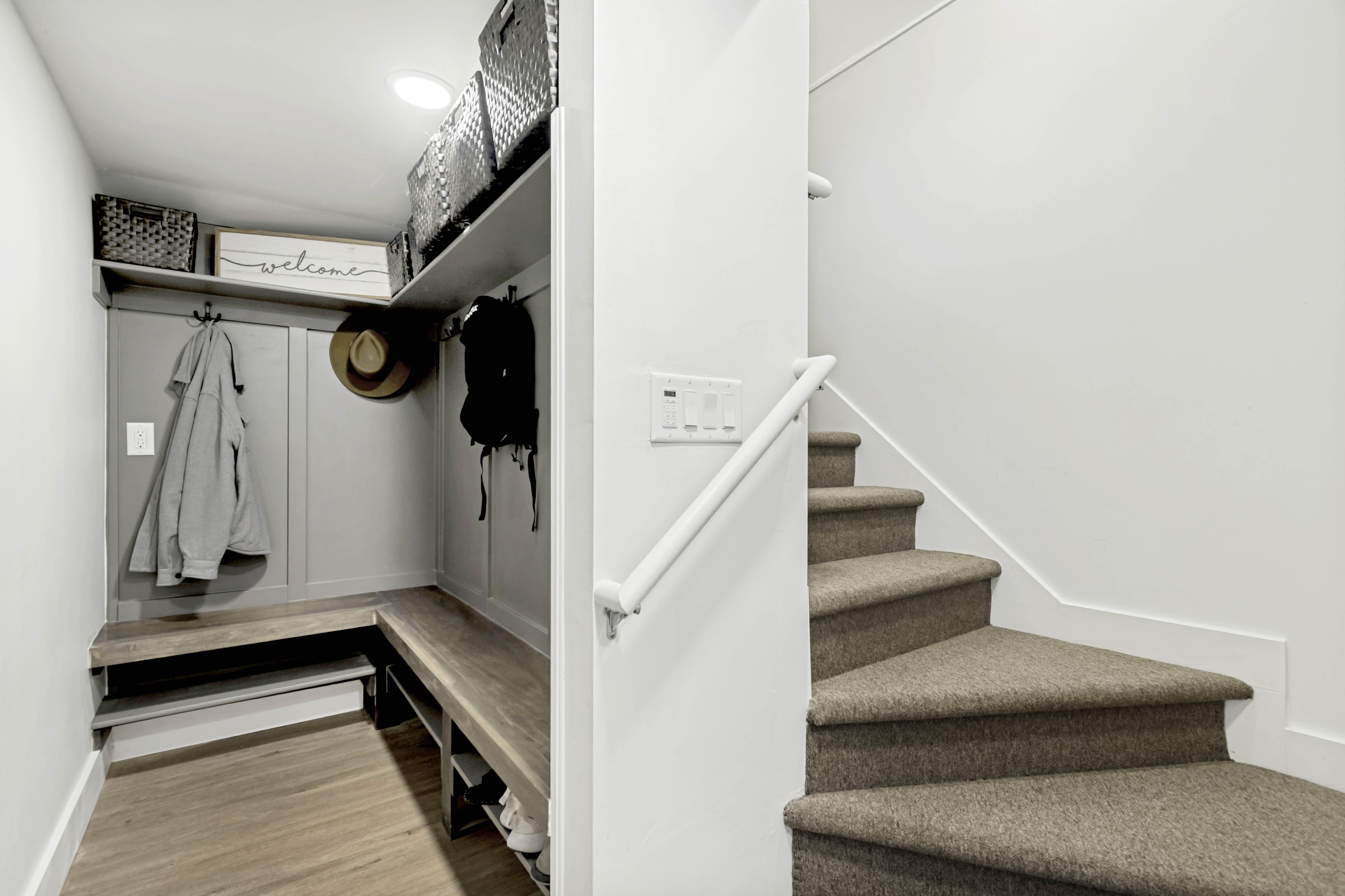 Built-in mudroom bench with wood-finish top and integrated storage
