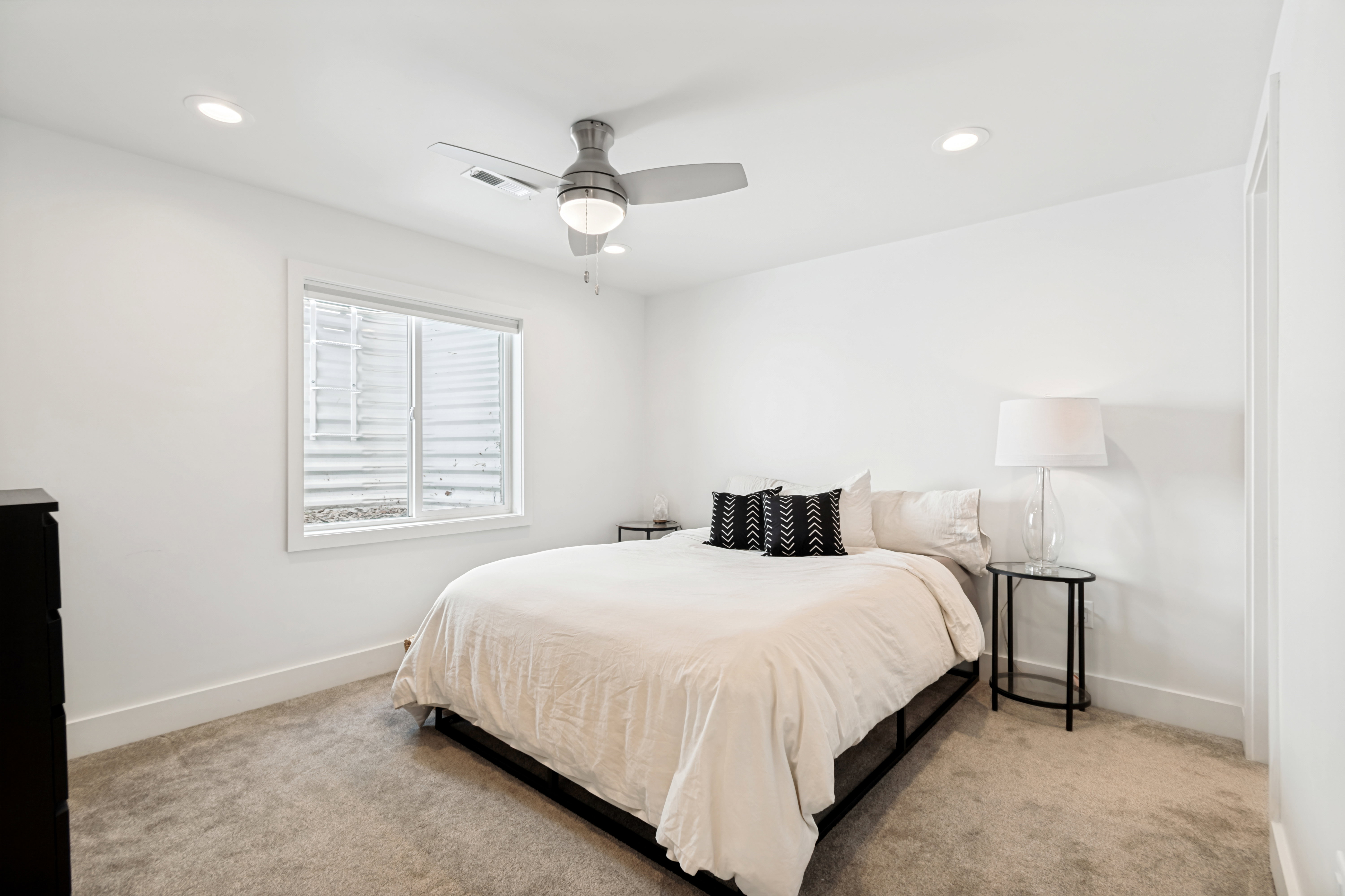 Bedroom featuring a window with white blinds, recessed lighting, a ceiling fan with integrated lighting, and light-colored carpeting