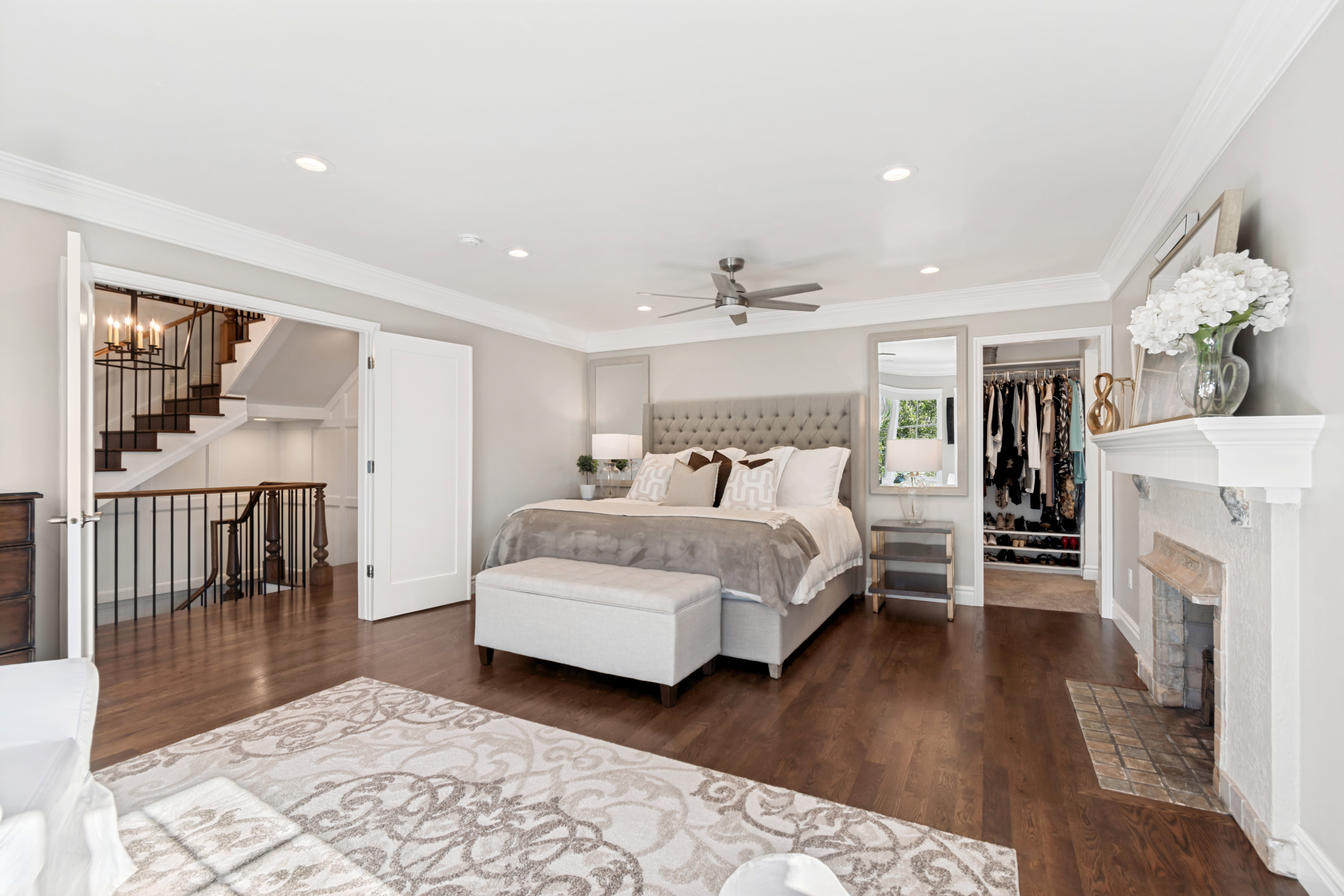 Spacious bedroom featuring wood-finish flooring, recessed lighting, and a ceiling fan