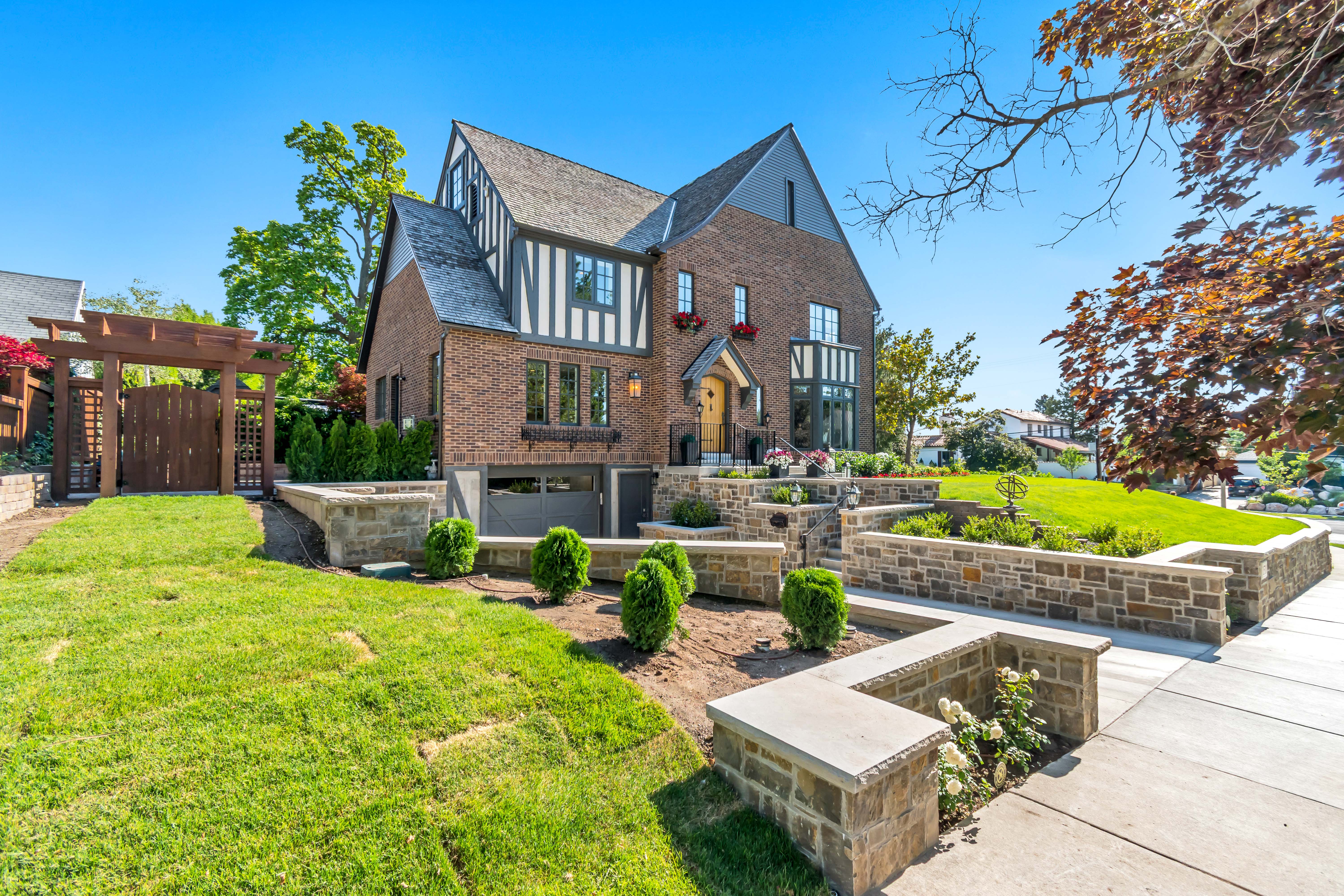 Tudor-style residence featuring a brick and half-timbered facade