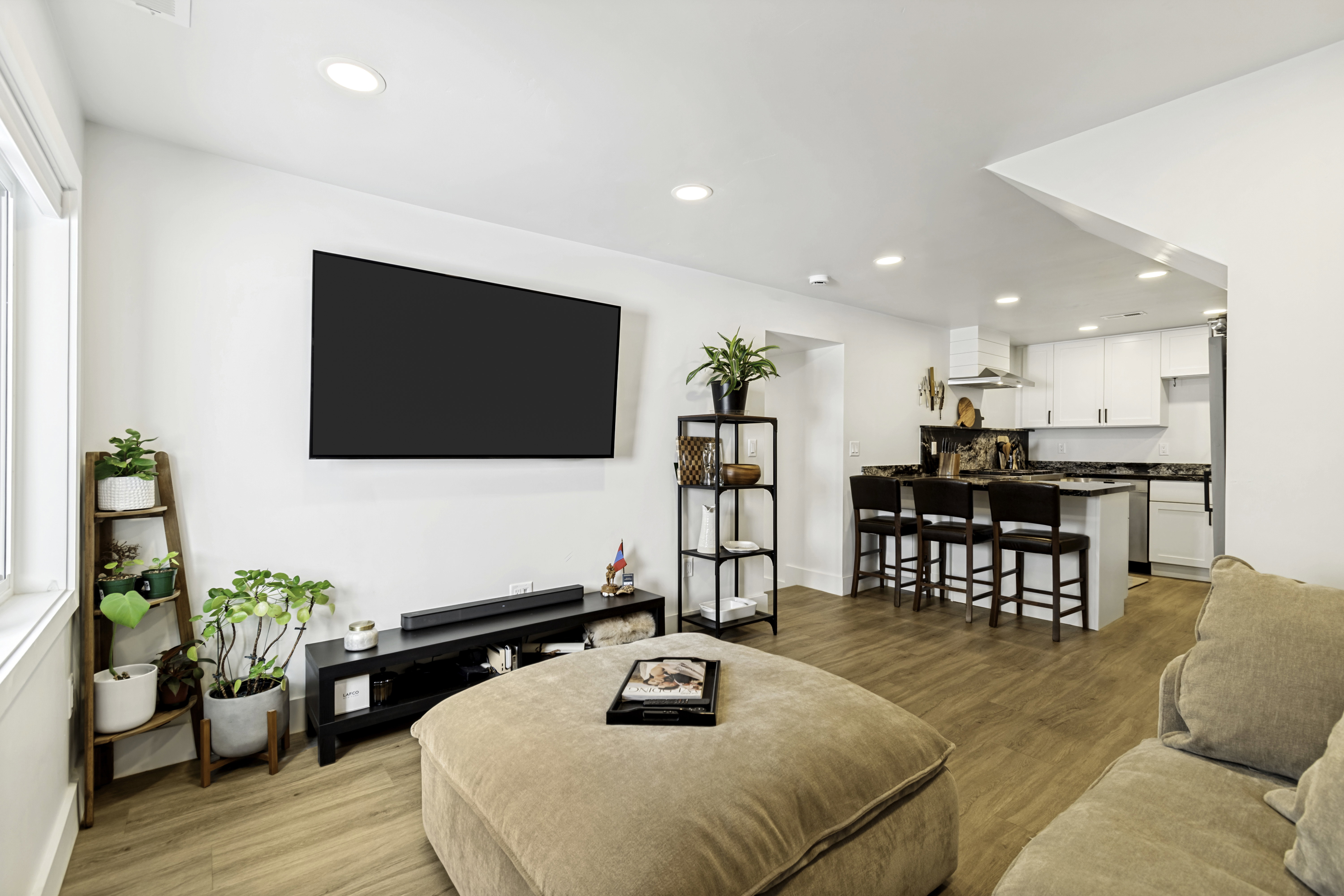 Open-concept living space featuring wood-finish flooring and recessed lighting
