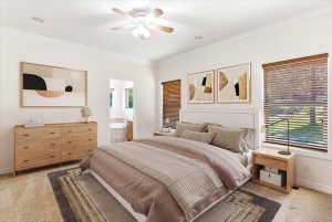 Carpeted bedroom featuring crown molding, a ceiling fan, and recessed lighting. Virtually staged.