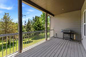 Expansive covered deck featuring composite decking and a durable metal railing