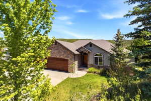 Stone and siding exterior with a wood-finish garage door