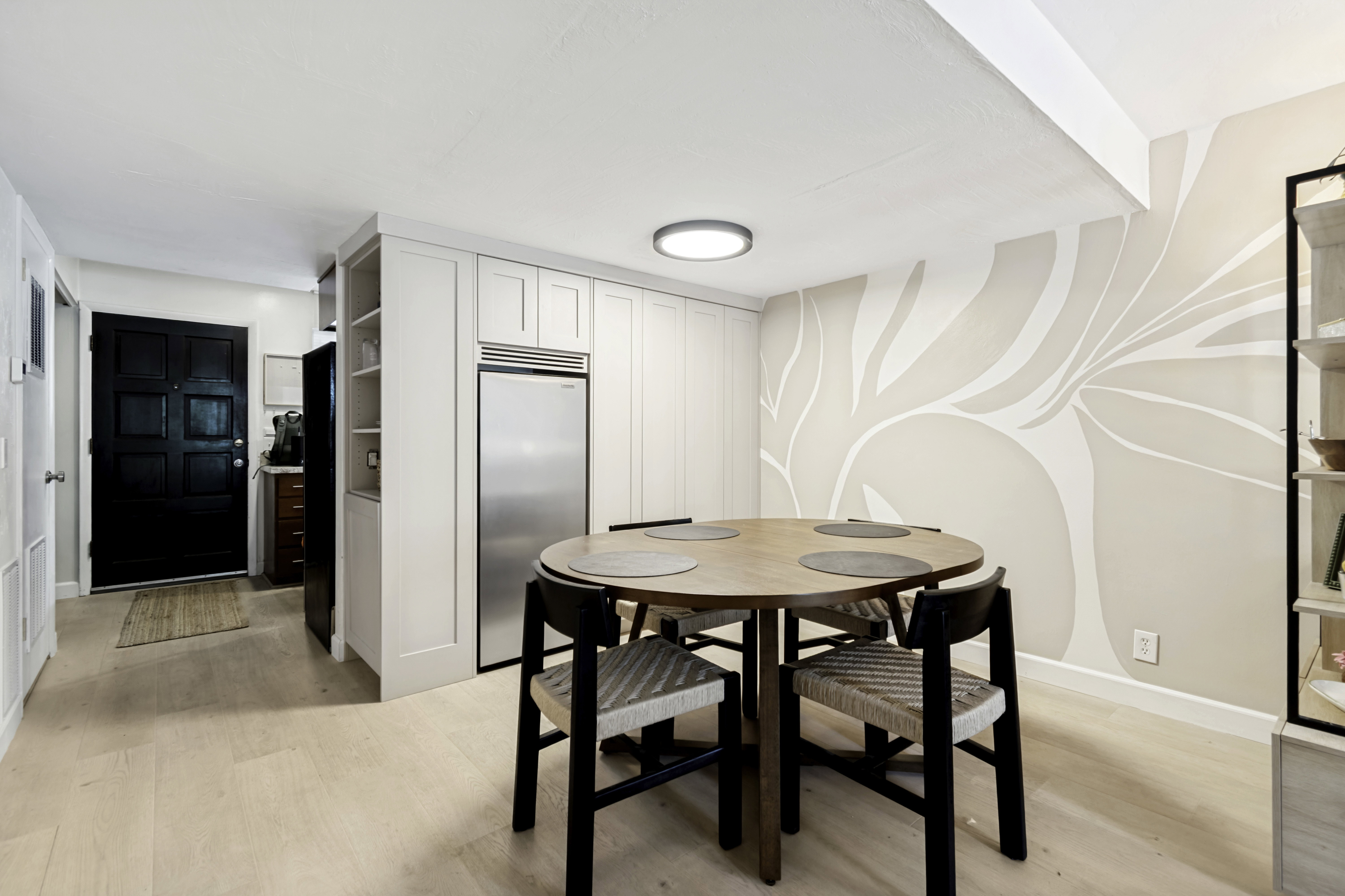 Light wood-finish flooring throughout, complemented by a recessed ceiling light
