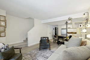 Open concept living area with light wood-finish flooring