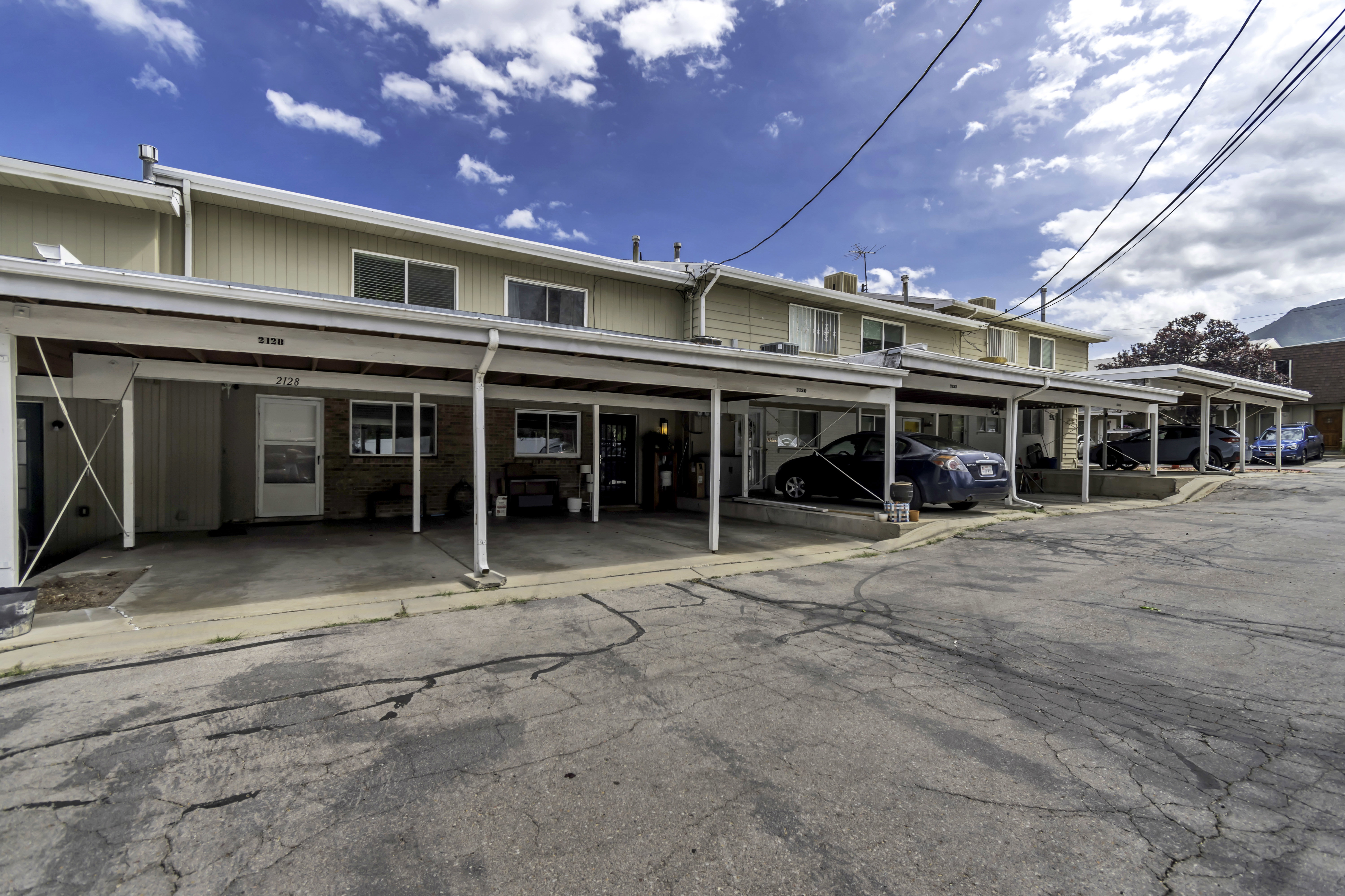 Row of residential units featuring individual covered carports